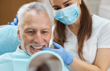 dentist showing patient new smile in mirror
